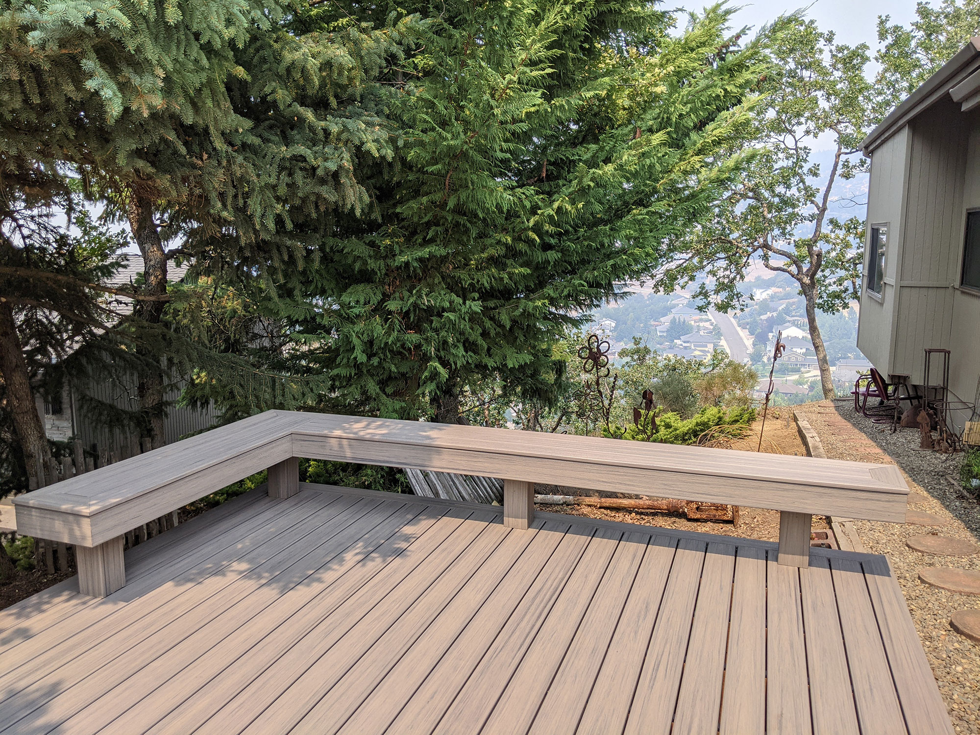 Deck built on hillside with bench railing
